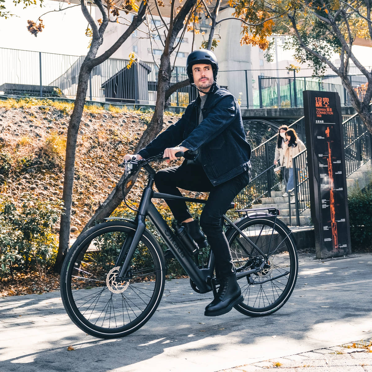 Rider effortlessly commuting in the city on a Matte Black Urban Cruise