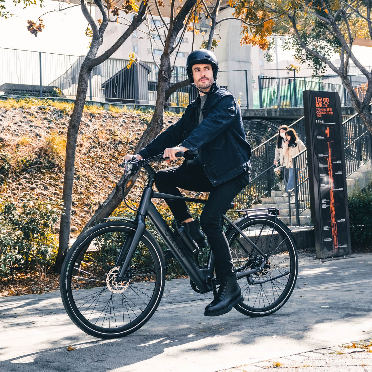 Rider effortlessly commuting in the city on a Matte Black Urban Cruise